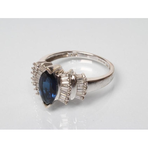 176 - A SAPPHIRE AND DIAMOND DRESS RING, the central marquise cut sapphire set to double fan shoulders poi... 