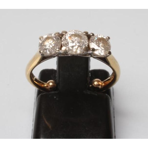 178 - A THREE STONE DIAMOND RING, the central brilliant cut stone of approximately 0.25cts claw set and fl... 