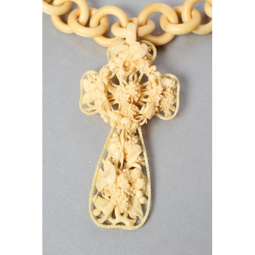 185 - A VICTORIAN IVORY CROSS PENDANT of open form, carved with lily of the valley and other flowers, 3 3/... 