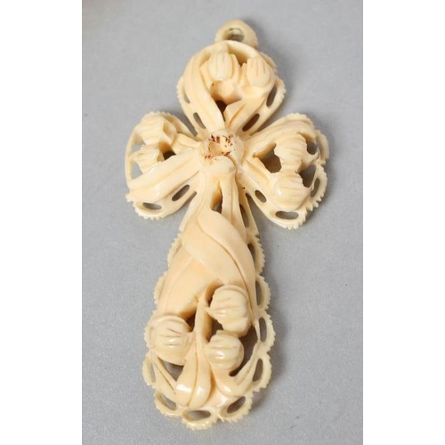 185 - A VICTORIAN IVORY CROSS PENDANT of open form, carved with lily of the valley and other flowers, 3 3/... 