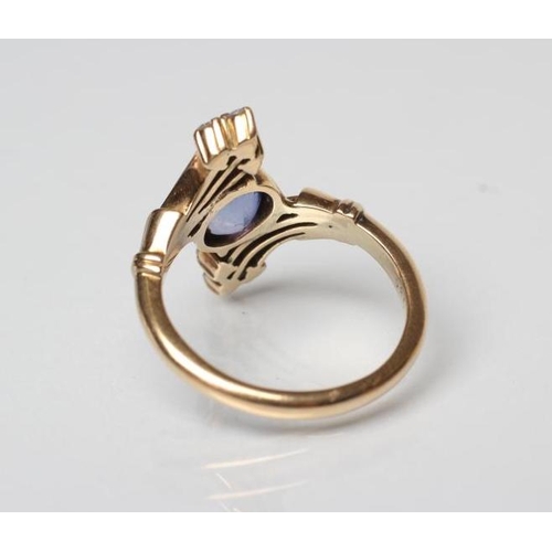 187 - A SAPPHIRE AND DIAMOND COCKTAIL RING, the oval facet cut sapphire diagonally claw set to triple edge... 