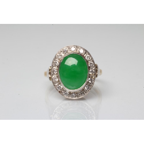 190 - AN EMERALD AND DIAMOND DRESS RING, the oval cabochon polished emerald open back collet set to a bord... 