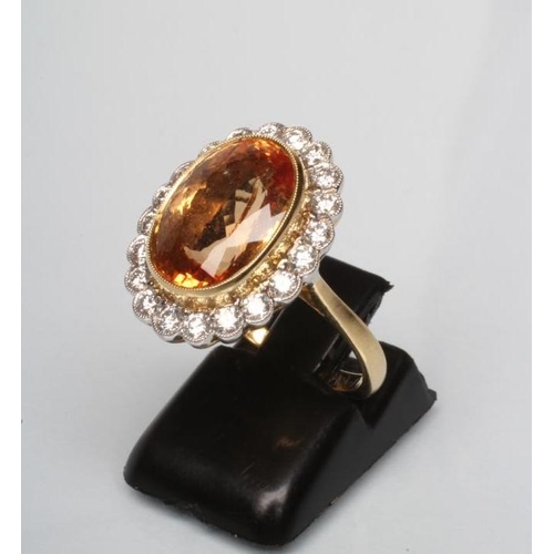 194 - A CITRINE AND DIAMOND DRESS RING, the oval facet cut citrine of approximately 7.5cts, open back coll... 