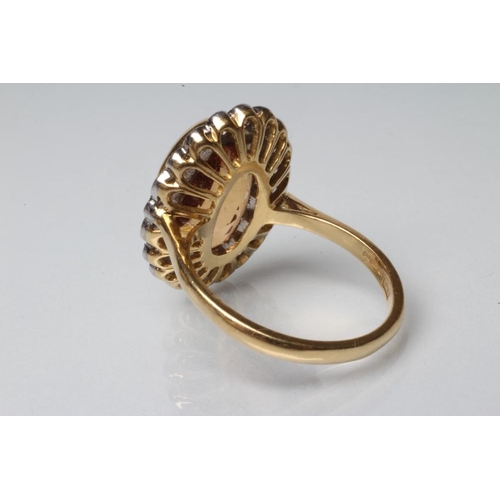 194 - A CITRINE AND DIAMOND DRESS RING, the oval facet cut citrine of approximately 7.5cts, open back coll... 