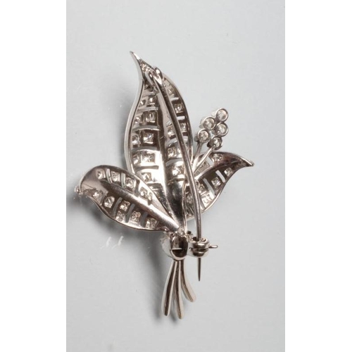 196 - A DIAMOND LEAF BROOCH, the three open work leaves point set with small round brilliant cut stones an... 