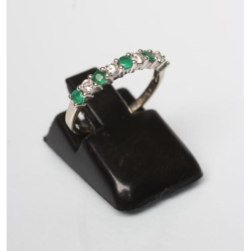 197 - AN EMERALD AND DIAMOND HALF HOOP ETERNITY RING, the five emeralds and four diamonds point set to a p... 