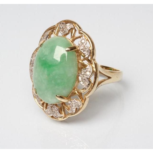 198 - A COCKTAIL RING, the oval cabochon polished jadeite panel claw set to an open floriform border set w... 