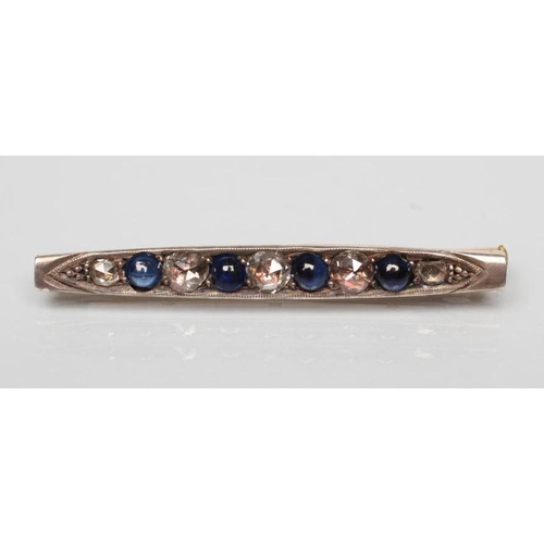 201 - A SAPPHIRE AND DIAMOND BAR BROOCH, the four circular cabochon polished sapphires with five rose cut ... 