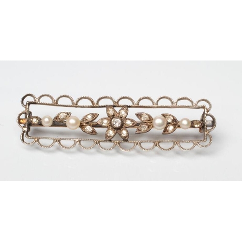 213 - A LATE VICTORIAN BROOCH, the open wirework oblong panel centred by a diamond flowerhead cluster with... 