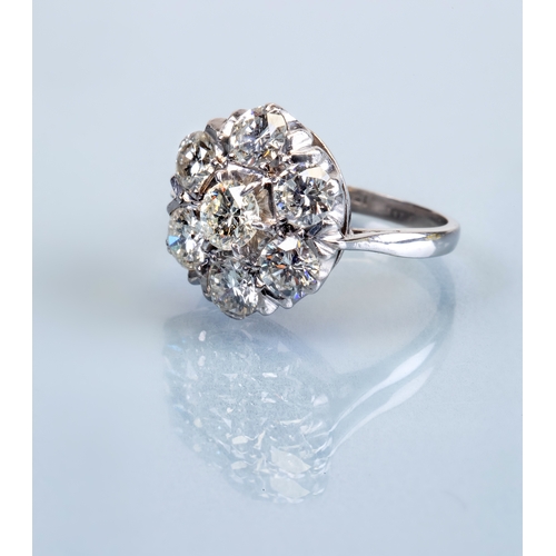 218 - A DIAMOND CLUSTER RING, the seven round brilliant cut stones totalling approximately 3.50cts, claw s... 