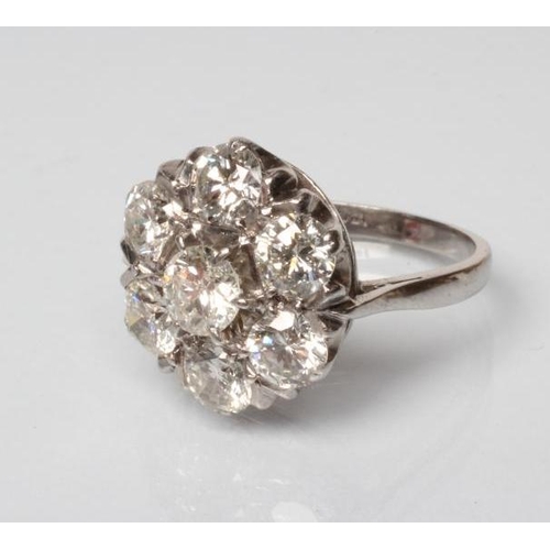 218 - A DIAMOND CLUSTER RING, the seven round brilliant cut stones totalling approximately 3.50cts, claw s... 