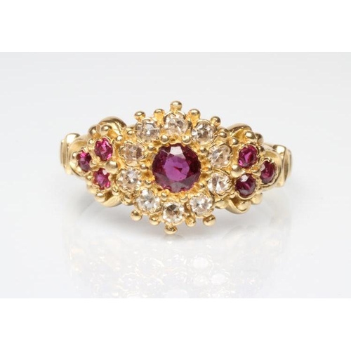 221 - A RUBY AND DIAMOND CLUSTER DRESS RING, the central facet cut ruby within a border of ten round brill... 