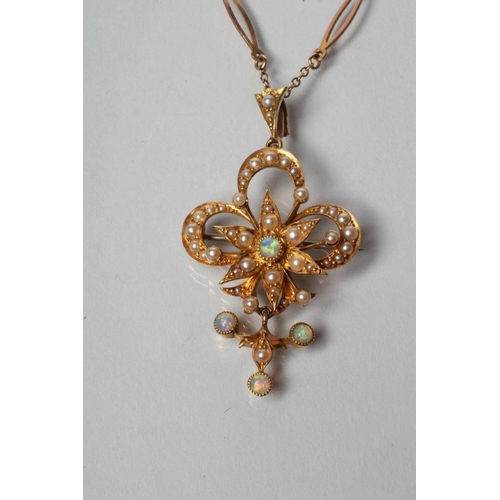 222 - AN EDWARDIAN PENDANT/BROOCH, the open trefoil centred by a star all set with seed pearls and opal ce... 