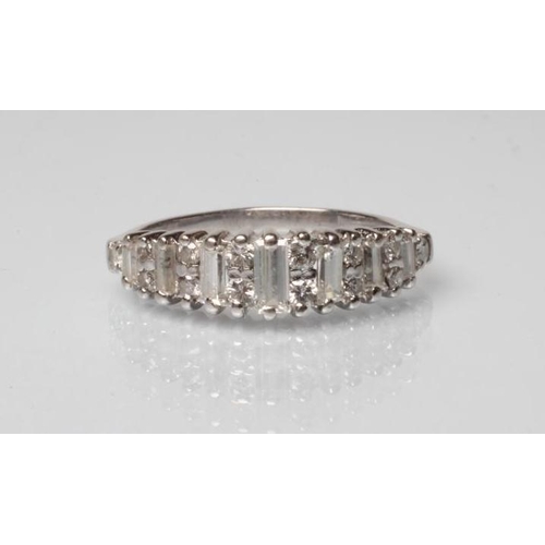 223 - A DIAMOND HALF HOOP RING, the seven graduated baguette cut stones interspersed with point set small ... 