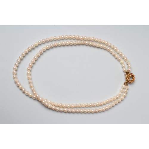 224 - A DOUBLE STRING CULTURED PEARL NECKLACE, the seventy three and sixty five pearls on an 18ct gold det... 