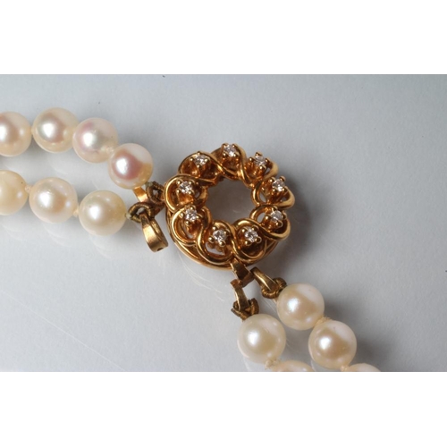 224 - A DOUBLE STRING CULTURED PEARL NECKLACE, the seventy three and sixty five pearls on an 18ct gold det... 