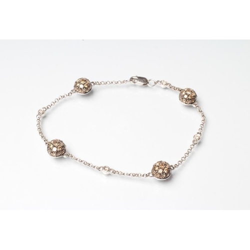 230 - A DIAMOND BRACELET, the four bosses each set with numerous brown stones with white diamond spacers a... 