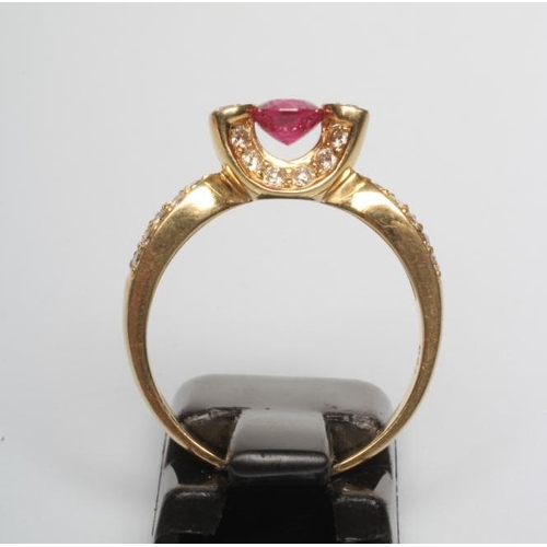 239 - A RUBY AND DIAMOND COCKTAIL RING, the circular facet cut ruby prong set between two pairs of diamond... 