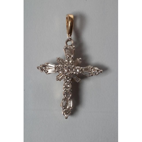 241 - A DIAMOND CROSS PENDANT, the twelve baguette and nine round brilliant cut stones point set to a yell... 