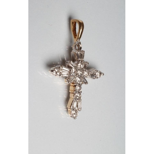 241 - A DIAMOND CROSS PENDANT, the twelve baguette and nine round brilliant cut stones point set to a yell... 