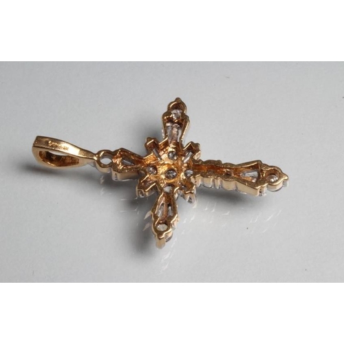 241 - A DIAMOND CROSS PENDANT, the twelve baguette and nine round brilliant cut stones point set to a yell... 