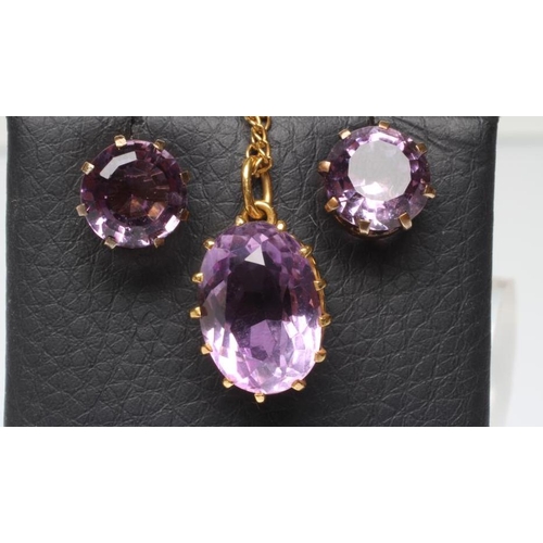 242 - AN AMETHYST PENDANT, the oval facet cut stone claw set to a plain frame, stamped 9ct, on unmarked ch... 