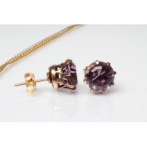 242 - AN AMETHYST PENDANT, the oval facet cut stone claw set to a plain frame, stamped 9ct, on unmarked ch... 