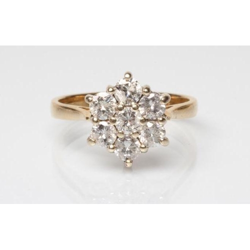 243 - A DIAMOND CLUSTER RING, the seven round brilliants claw set to a plain 18ct gold shank, Sheffield, s... 