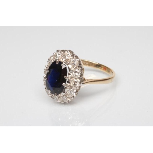 245 - A SAPPHIRE AND DIAMOND CLUSTER RING, the oval facet cut sapphire claw set to a border of twelve roun... 