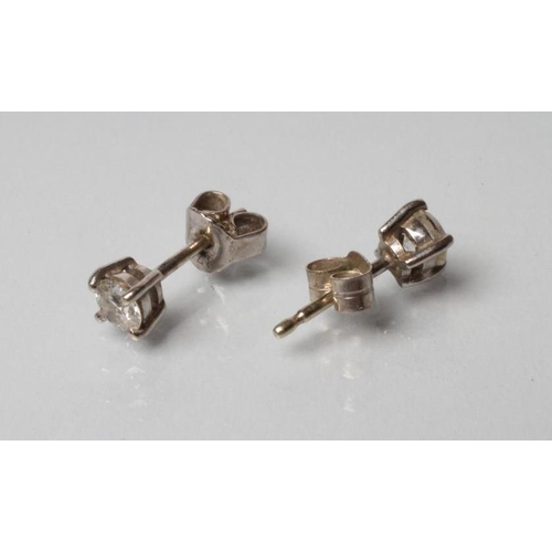 248 - A PAIR OF SOLITAIRE DIAMOND STUD EARRINGS, the claw set round brilliant totalling approximately 0.6c... 