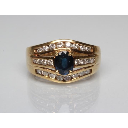 249 - A SAPPHIRE AND DIAMOND DRESS RING, the oval facet cut sapphire claw set to an open triple panel chan... 