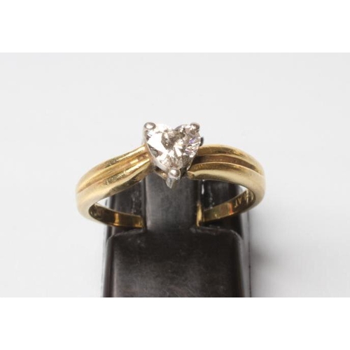 257 - A SOLITAIRE DIAMOND RING, the heart cut stone of 0.89ct point set to reeded shoulders and a plain sh... 