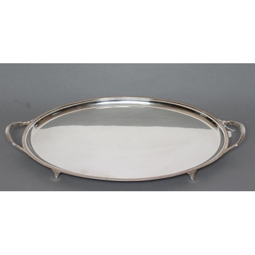 86 - A TEA TRAY, maker Harrison Bros. & Houson, Sheffield 1931, of plain oval form with straight gadroon ... 