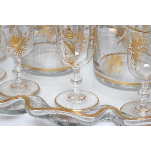 51 - A FRENCH GLASS LIQUEUR SET, 19th century, comprising pair of mallet decanters with globular stoppers... 