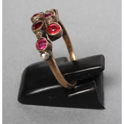 230 - A VICTORIAN RUBY AND DIAMOND CROSSOVER RING collet set with six rubies and five rose cut diamonds to... 