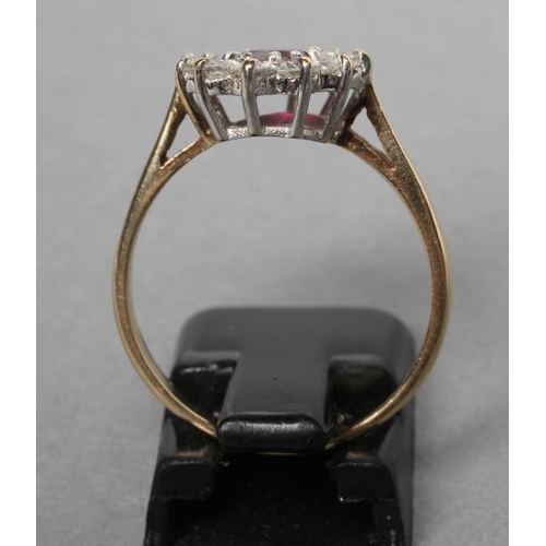 254 - A RUBY AND DIAMOND CLUSTER RING, the oval facet cut ruby claw set to a border of twelve round brilli... 