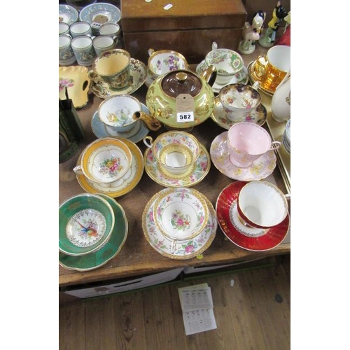 582 - ELEVEN ASSORTED CHINA CUPS AND SAUCERS WITH A LUSTRE WARE TEAPOT