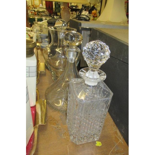 597 - THREE DECANTERS AND A VASE