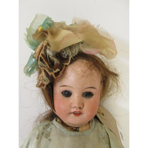 10 - An SFBJ bisque socket head doll, with brown glass sleeping eyes, open mouth and teeth, wood and comp... 