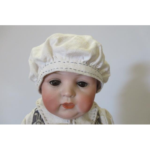 122 - A rare Swaine & Co. bisque socket head solemn boy doll, with blue glass sleeping eyes, open-closed m... 