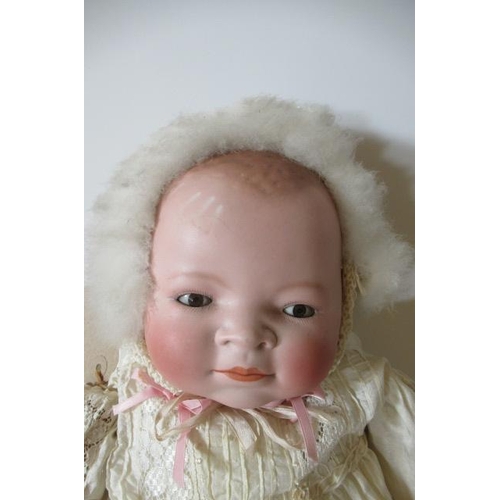 133 - A bisque head flange neck baby doll, by Grace S Putnam, with brown sleeping eyes, closed mouth, moul... 