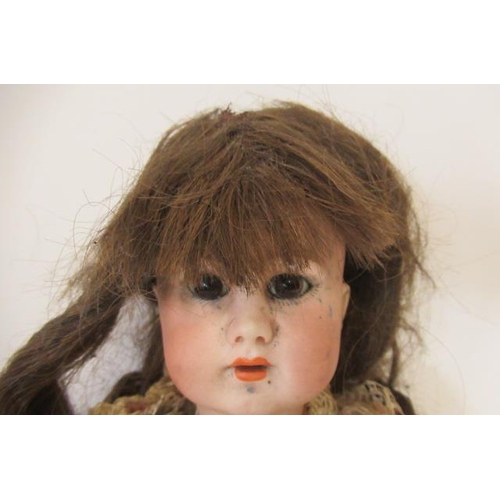 16 - A French bisque socket head walking doll, with brown glass fixed eyes, open mouth, teeth, pierced ea... 