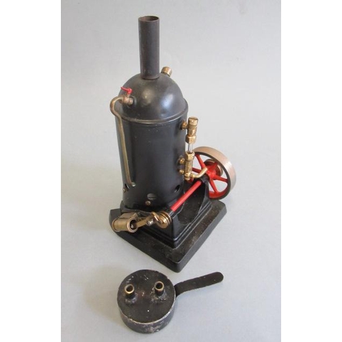 239 - Small vertical spirit fired steam engine, single cylinder, domed boiler, with water gauge, on cast i... 