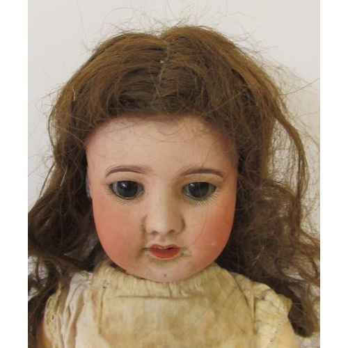 24 - An SFBJ bisque socket head doll, with brown glass sleeping eyes, open mouth and teeth, wood and comp... 