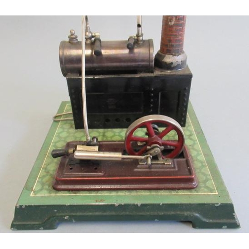 244 - Bing spirit fired stationary steam engine with black plated boiler, brick chimney, printed tile base... 