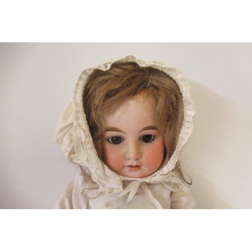 28 - An Armand Marseille bisque socket head doll, with brown glass sleeping eyes, open mouth and teeth, w... 