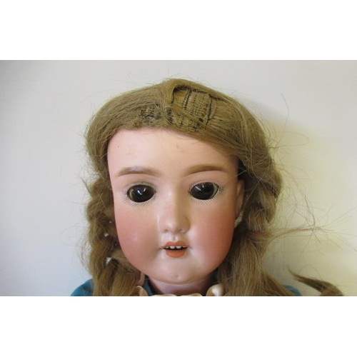 3 - A German bisque socket head doll, with brown glass sleeping eyes, open mouth and teeth, wood and com... 