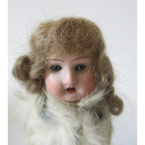 31 - A Theodore Recknagel bisque socket head Eskimo doll, with blue glass fixed eyes, open mouth and teet... 