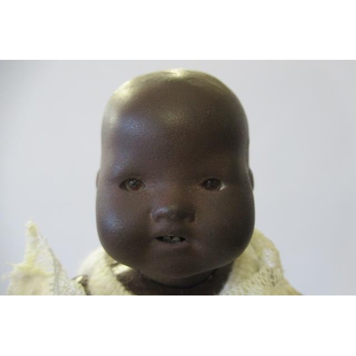 50 - An Armand Marseille bisque black baby doll, with brown glass eyes, open mouth, two bottom teeth, and... 