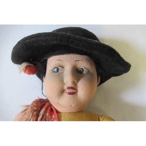 64 - A Norah Wellings cowgirl, with felt face, long skirt, sash and hat, 19